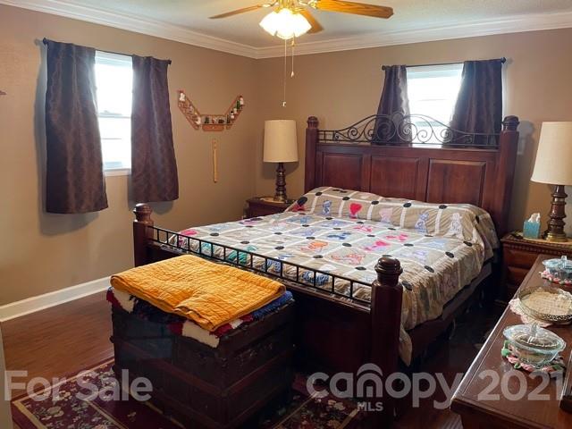 845 Sandy Level Church Road Bostic, NC 28018 - Photo 22 of 46 a bedroom with a bed and a chandelier