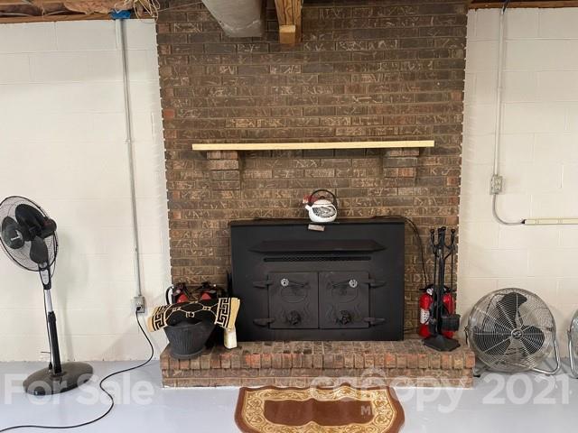 845 Sandy Level Church Road Bostic, NC 28018 - Photo 31 of 46 a room with a fireplace and a mirror