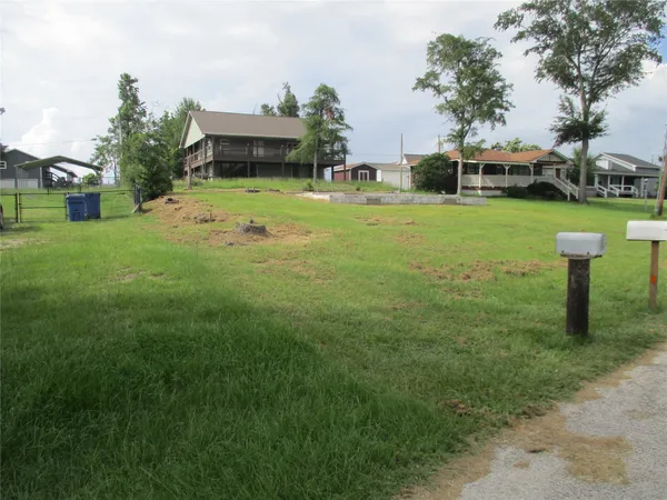 a view of a house with a yard and sitting area