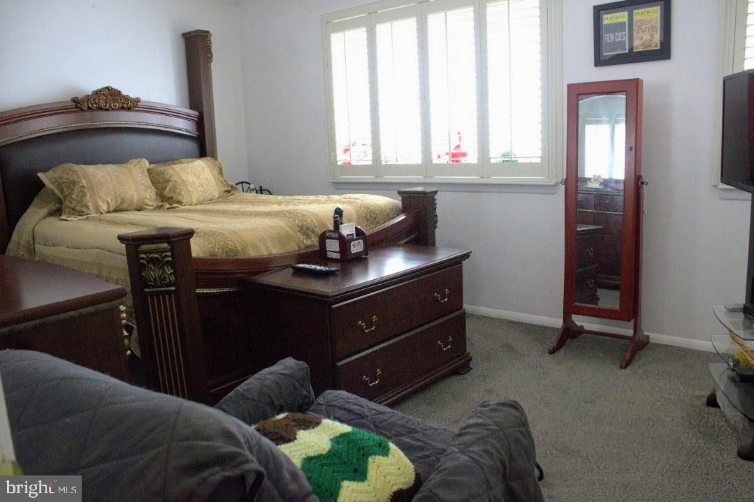 1902 Valley Terrace Southeast Washington, DC 20032 - Photo 18 of 38 a bedroom with a bed and a window