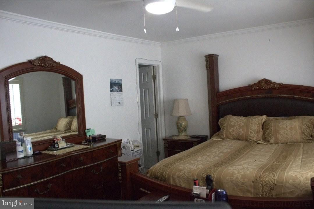 1902 Valley Terrace Southeast Washington, DC 20032 - Photo 19 of 38 a bedroom with a bed and a mirror on dresser