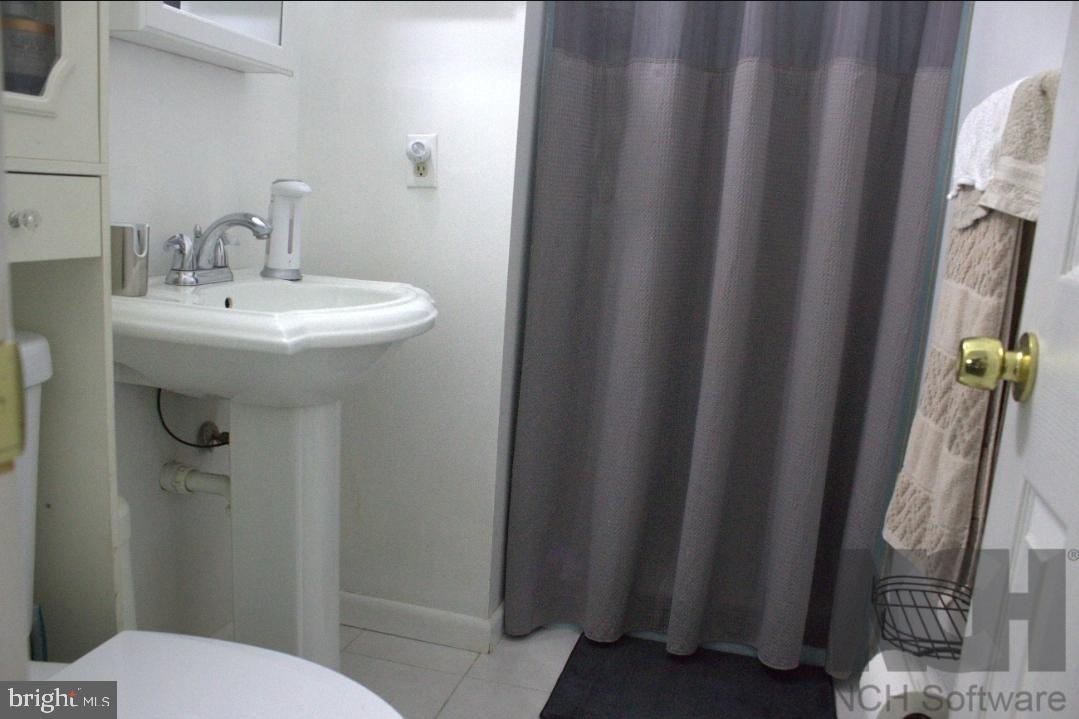 1902 Valley Terrace Southeast Washington, DC 20032 - Photo 22 of 38 a bathroom with sink and mirror