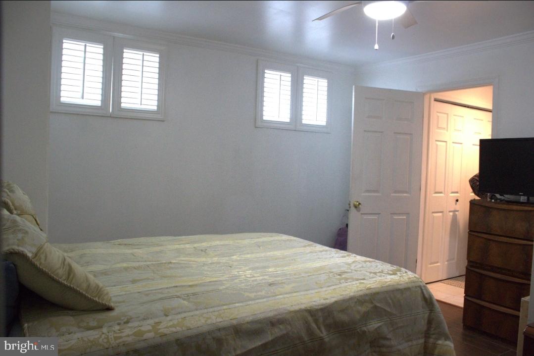 1902 Valley Terrace Southeast Washington, DC 20032 - Photo 24 of 38 a bedroom with a bed and a tv