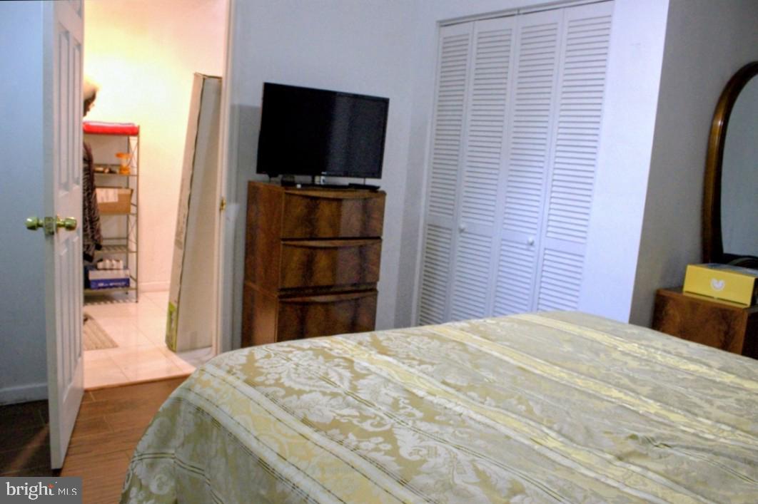 1902 Valley Terrace Southeast Washington, DC 20032 - Photo 25 of 38 a bedroom with a bed and a flat screen tv