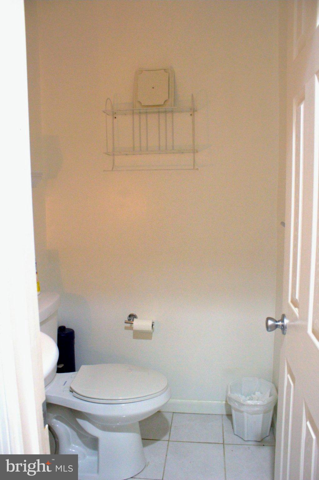 1902 Valley Terrace Southeast Washington, DC 20032 - Photo 26 of 38 a white toilet sitting next to a shower curtain
