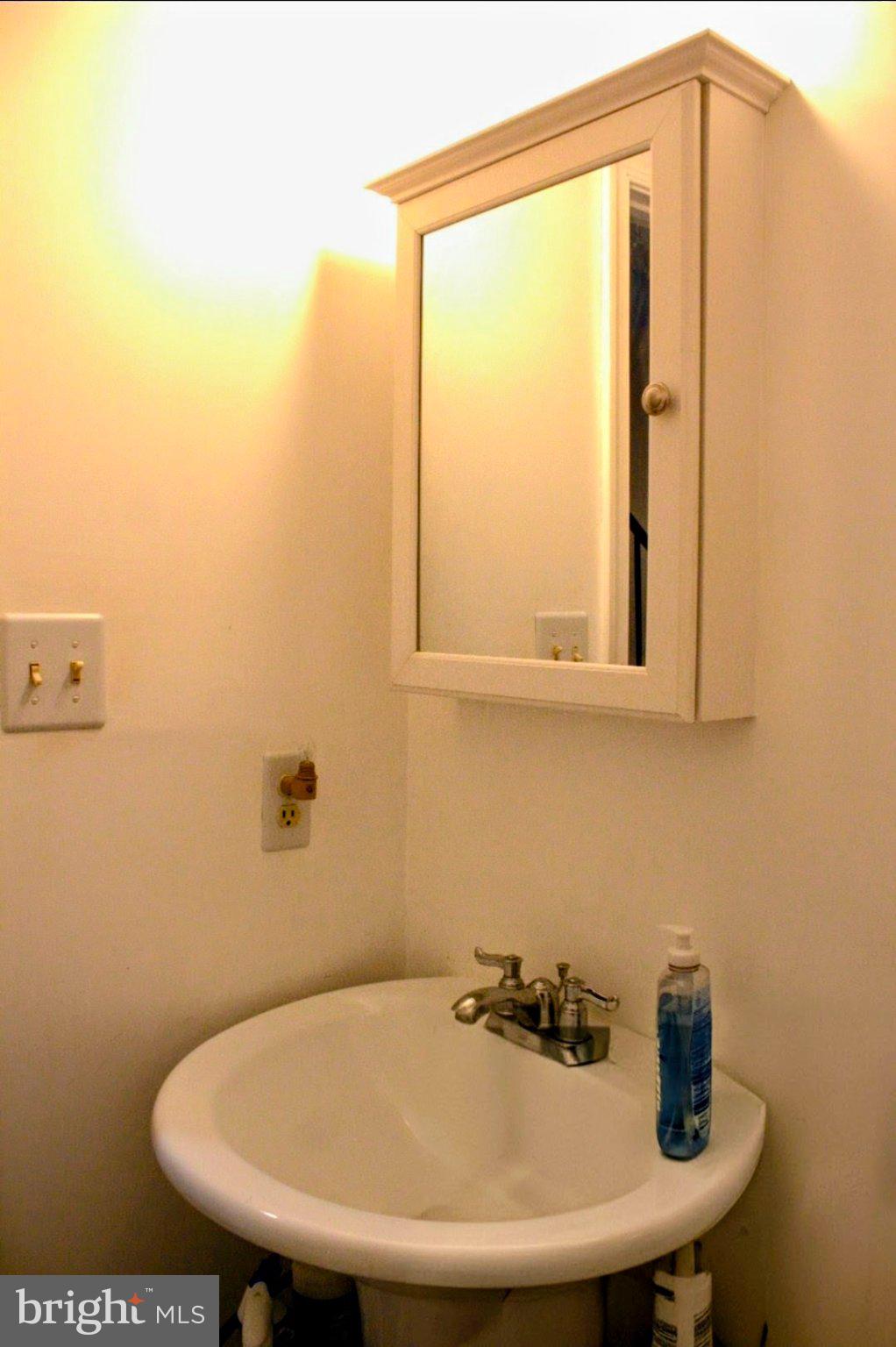 1902 Valley Terrace Southeast Washington, DC 20032 - Photo 27 of 38 a bathroom with a sink and a mirror