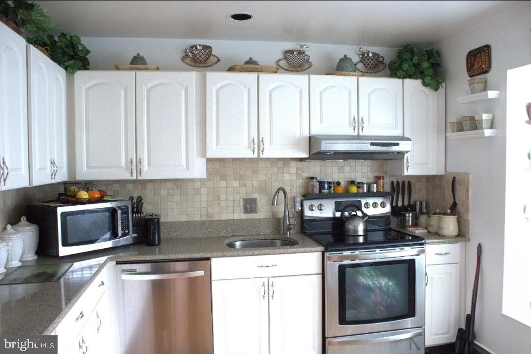 1902 Valley Terrace Southeast Washington, DC 20032 - Photo 6 of 38 a kitchen with stainless steel appliances granite countertop a stove a sink and a refrigerator