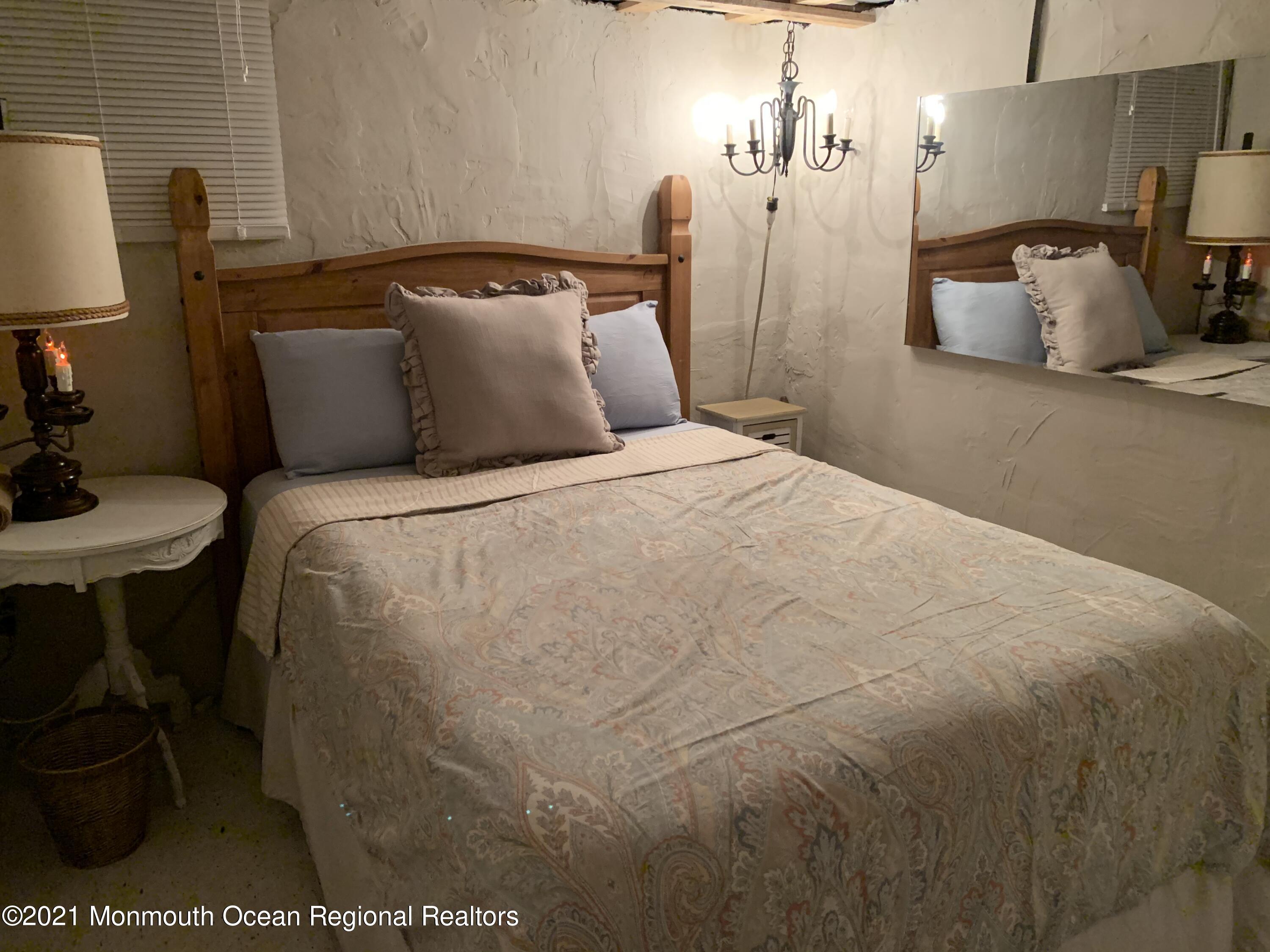 212 Oakhurst Road Oakhurst, NJ 07755 - Photo 27 of 35 a bedroom with a bed and a lamp