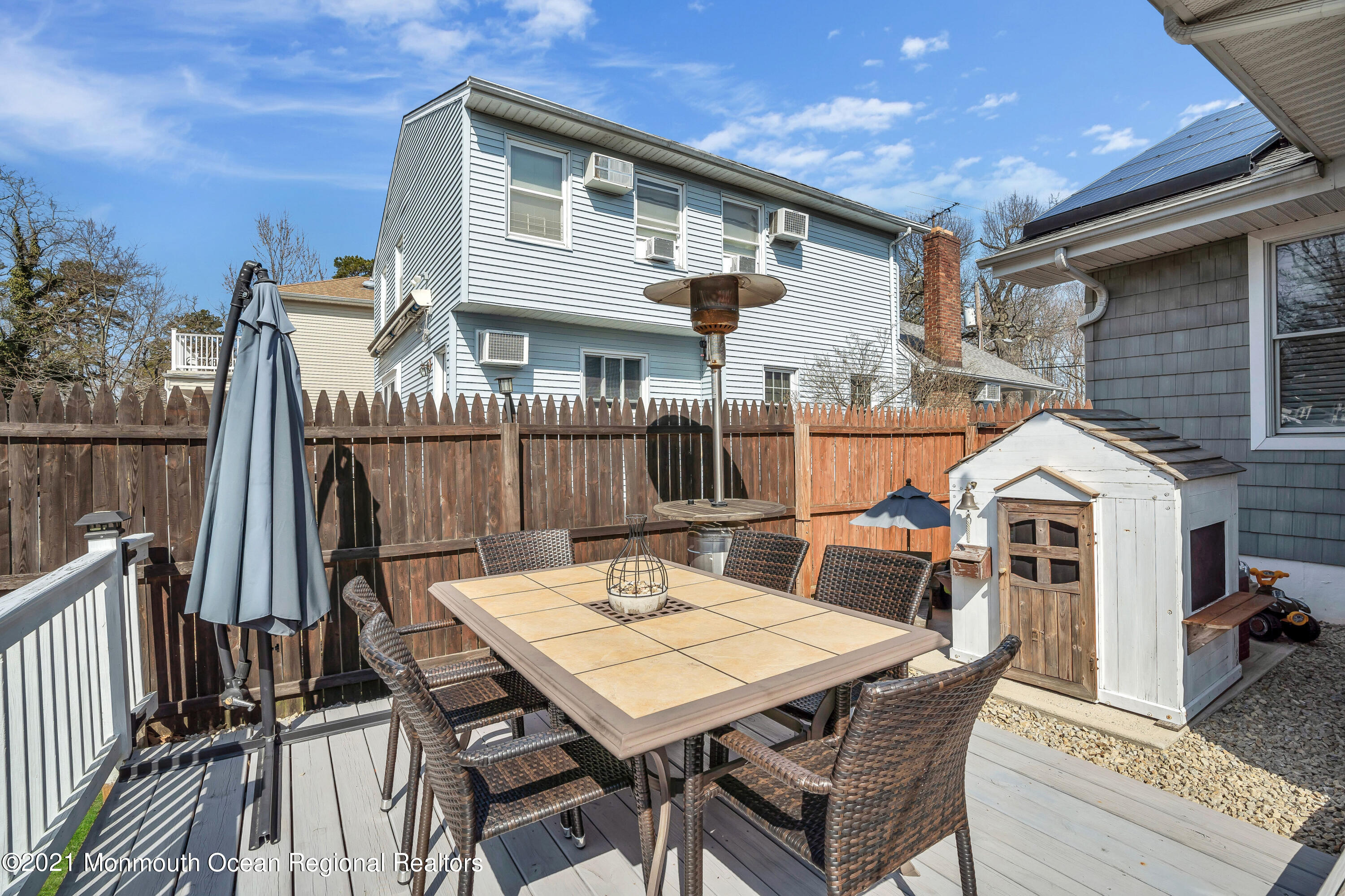 212 Oakhurst Road Oakhurst, NJ 07755 - Photo 31 of 35 a view of a patio with table and chairs a barbeque with wooden floor and fence