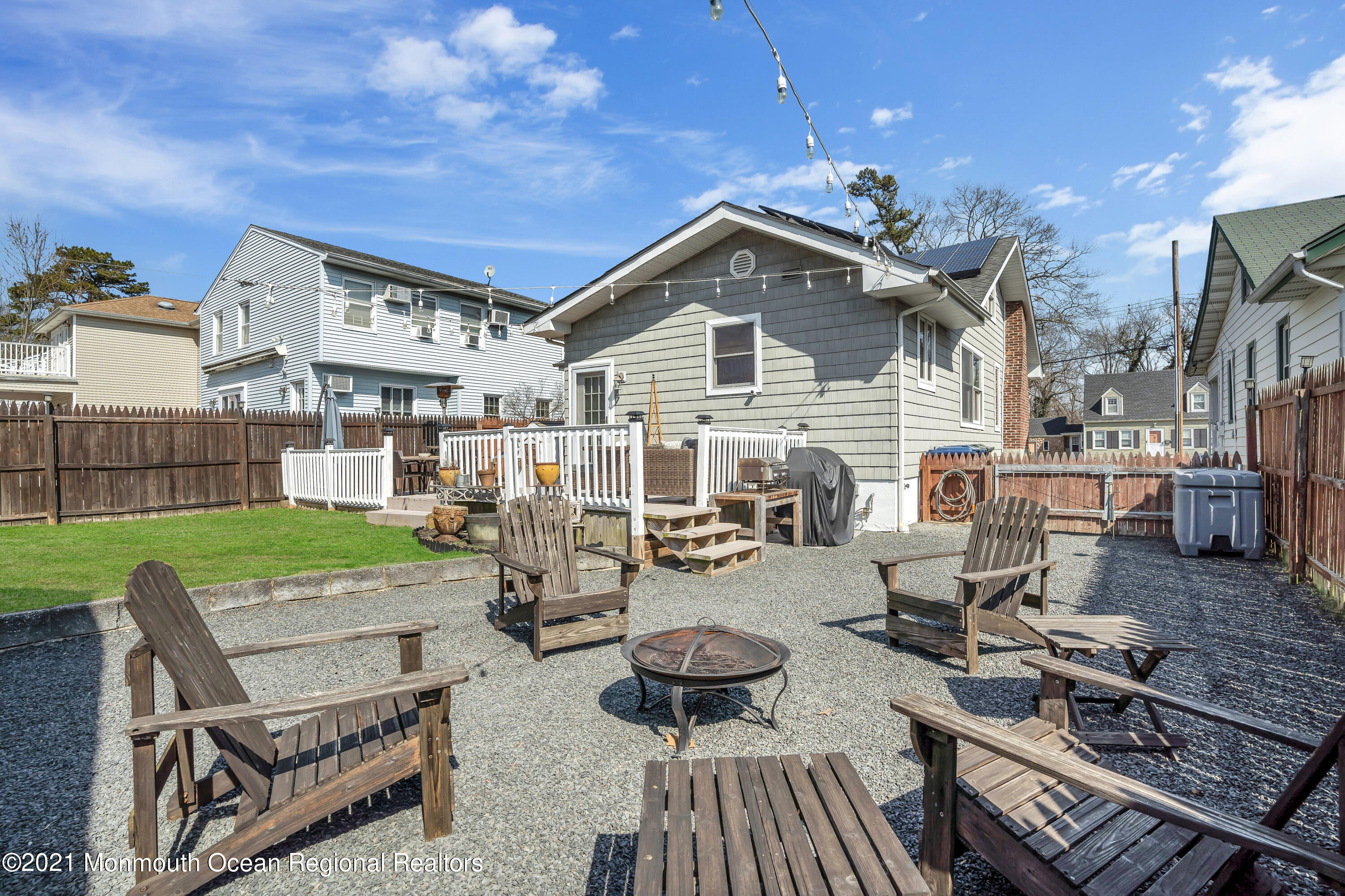 212 Oakhurst Road Oakhurst, NJ 07755 - Photo 32 of 35 a view of a patio with couches chairs and a fire pit