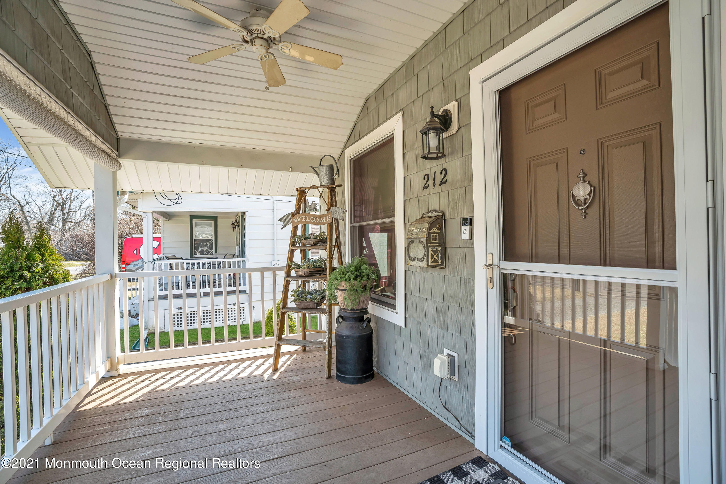 212 Oakhurst Road Oakhurst, NJ 07755 - Photo 5 of 35 a view of a porch with wooden floor and fence