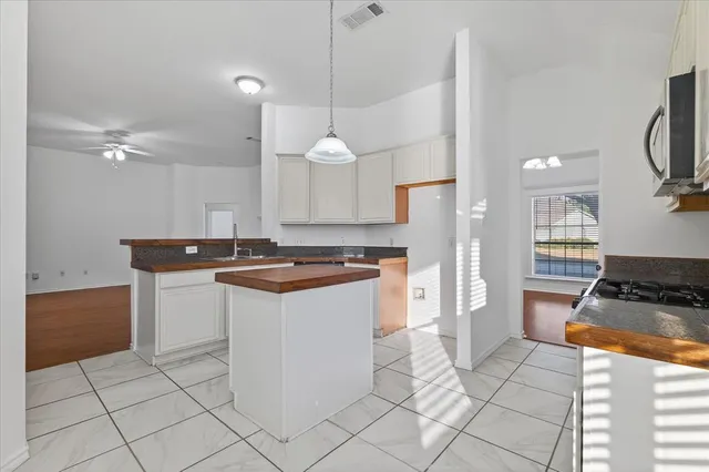 a kitchen with stainless steel appliances granite countertop a sink and a stove