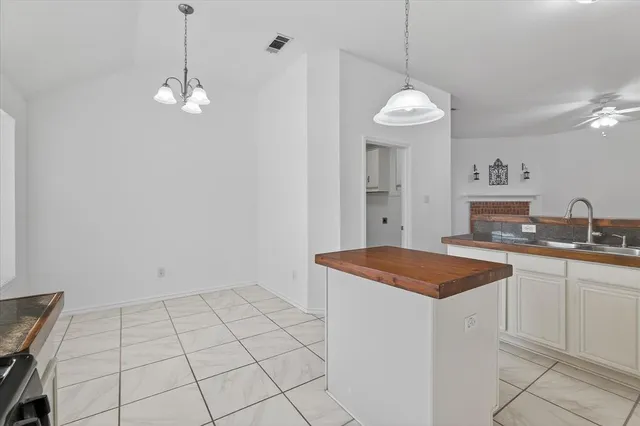 a very nice looking dining room with a sink and a chandelier