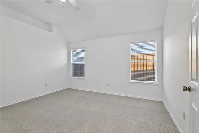 an empty room with a empty space and windows