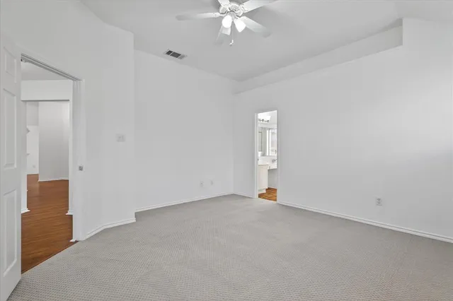 a bathroom with a sink a toilet a glass door a mirror and shower
