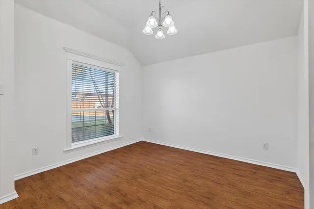 a view of wooden floor and chandelier in a room
