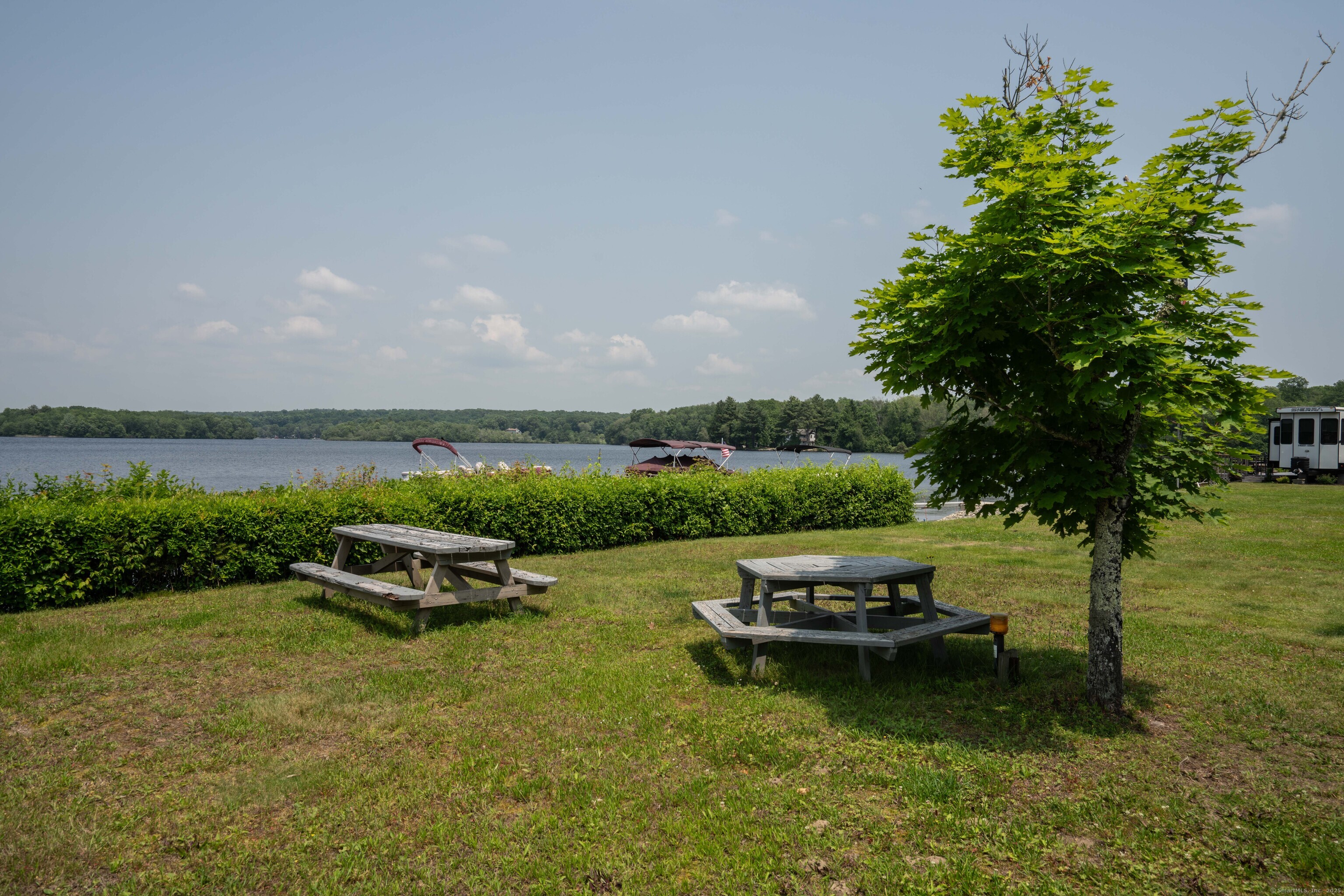 262 Shetucket Turnpike, Unit 2 Griswold, CT 06351 - Photo 15 of 26 a view of a lake with a yard swimming pool and outdoor seating
