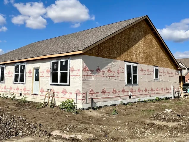 a view of a house with wooden fence