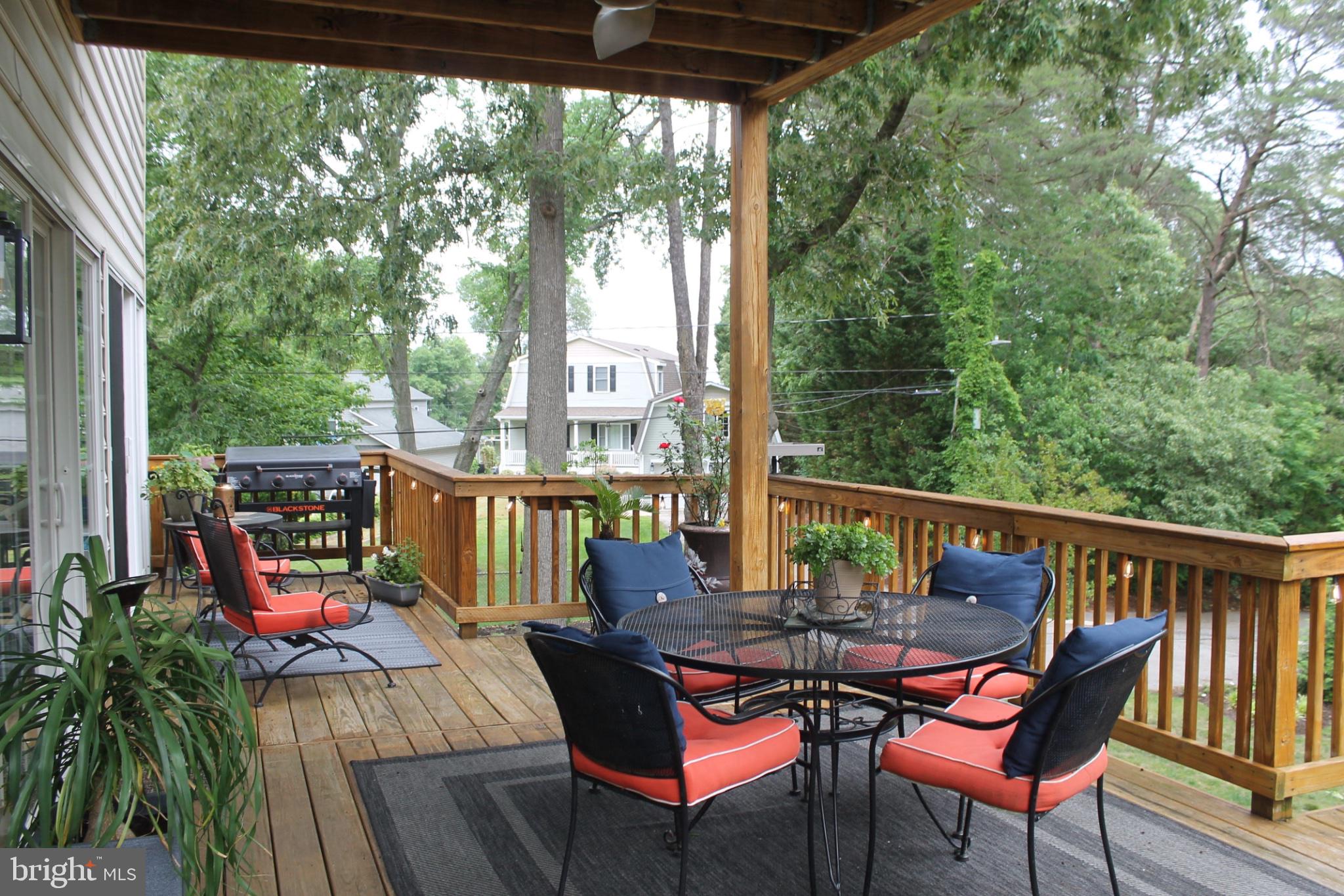 1219 Meadow View Road Pasadena, MD 21122 - Photo 8 of 16 Serene deck retreat amidst greenery.