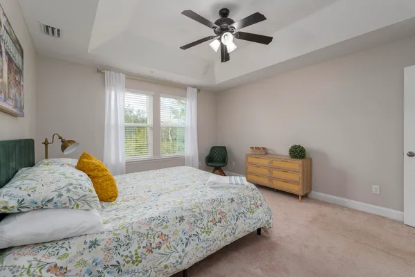 a bedroom with a bed and a chandelier