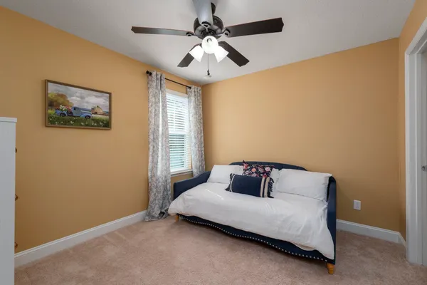 a bedroom with a bed and window