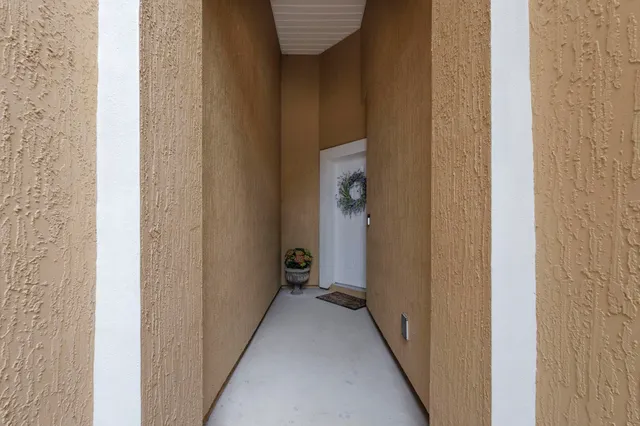 a view of a hallway with a wooden door