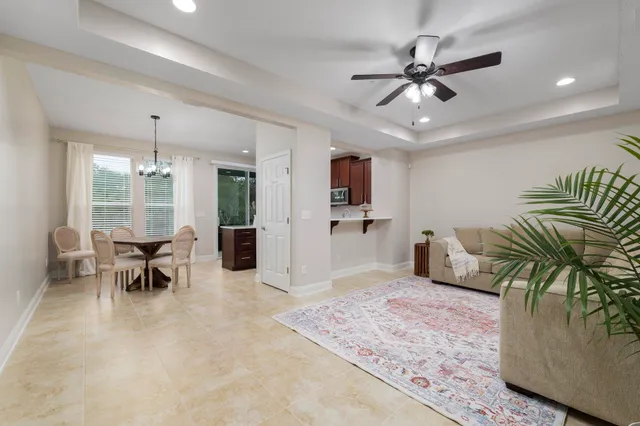 a living room with furniture and a chandelier
