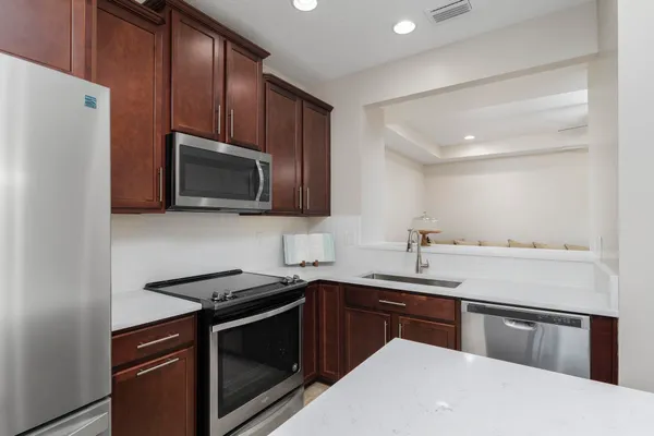 a kitchen with a sink appliances and cabinets