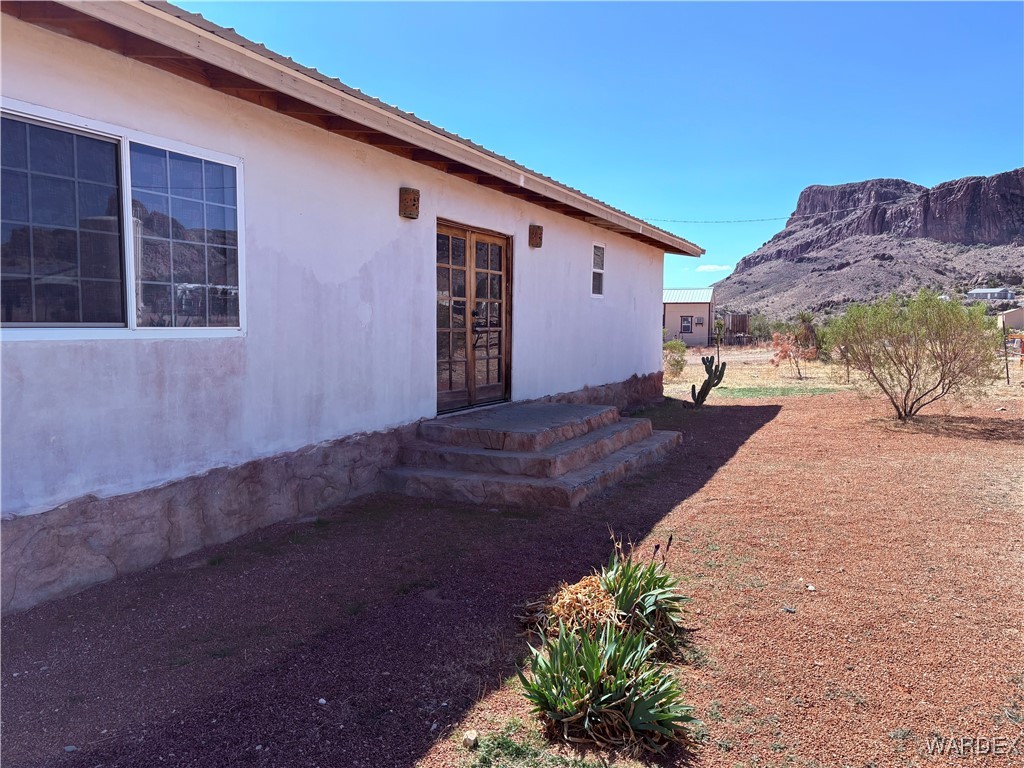 Entrance to property with stucco siding and a mountain view