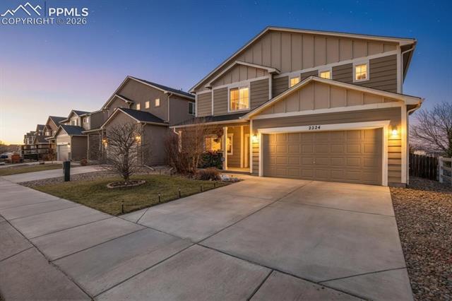 2224 Reed Grass Way Colorado Springs, CO 80915 - Photo 3 of 39 Craftsman-style home with board and batten siding, a garage, and concrete driveway