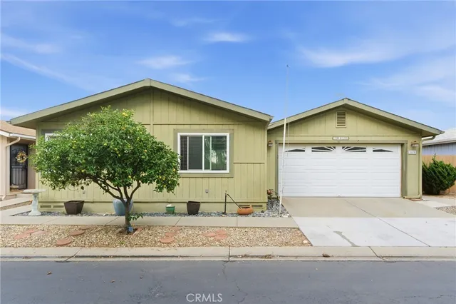 a view of a house with a yard and garage