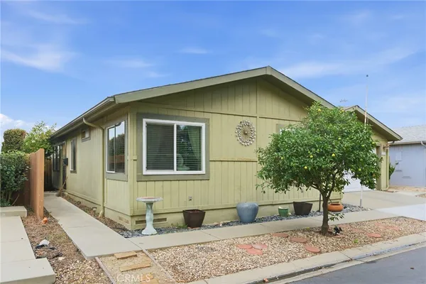 a view of a house with a backyard
