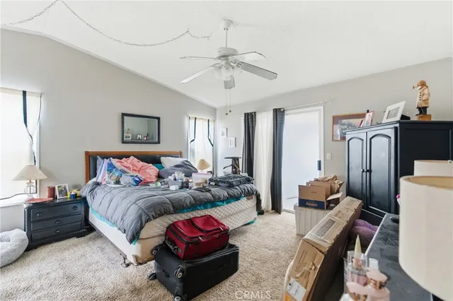 a living room with furniture a chandelier and a large mirror