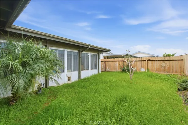 a view of a house with a yard and sitting area
