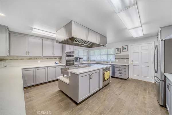 a kitchen with a stove sink and cabinets