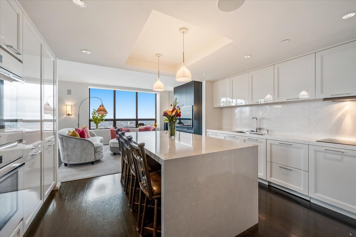 180 East Pearson Street, Unit 5107 Chicago, IL 60611 - Photo 11 of 42 a kitchen with counter top space a sink appliances and cabinets