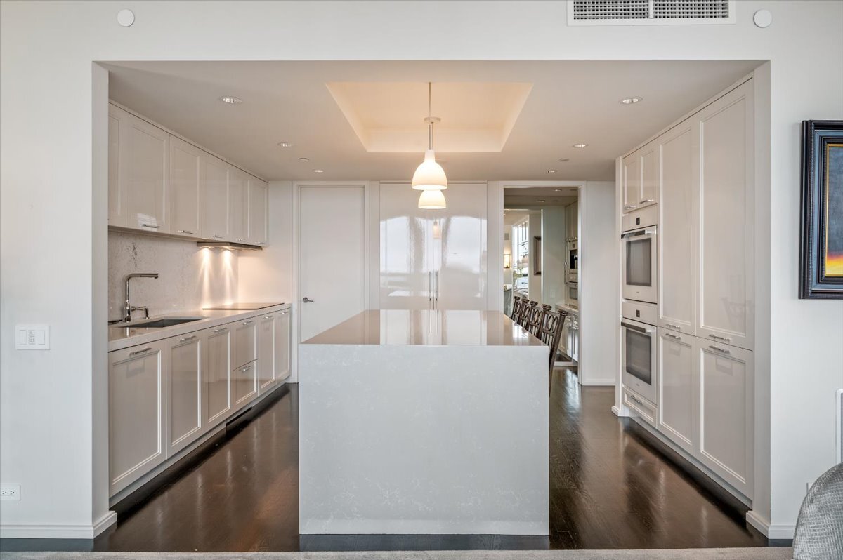 180 East Pearson Street, Unit 5107 Chicago, IL 60611 - Photo 13 of 42 a kitchen with granite countertop a refrigerator and a stove top oven