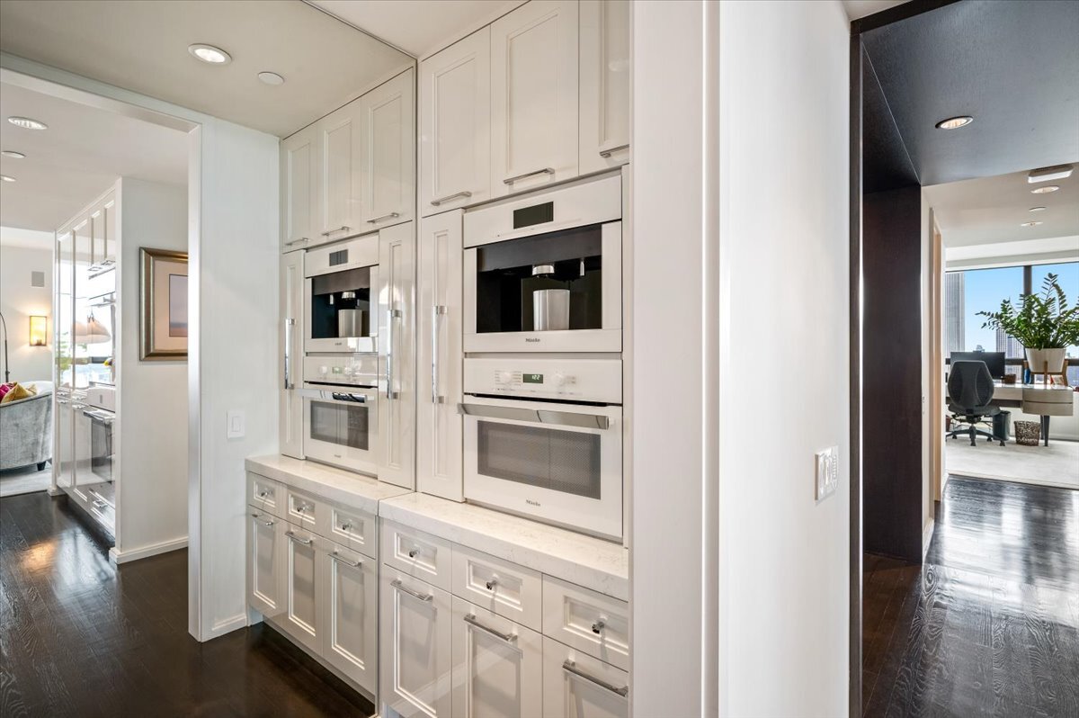 180 East Pearson Street, Unit 5107 Chicago, IL 60611 - Photo 15 of 42 a kitchen with stainless steel appliances a white stove top oven and a refrigerator