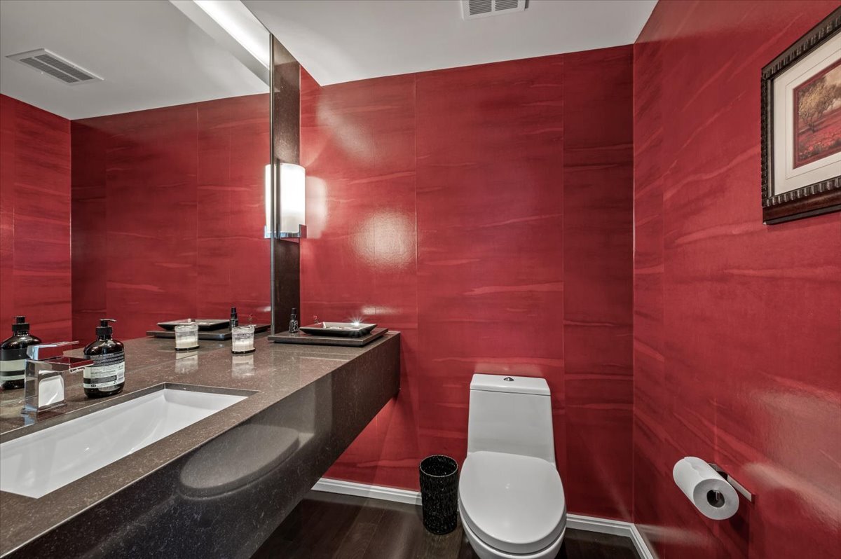 180 East Pearson Street, Unit 5107 Chicago, IL 60611 - Photo 17 of 42 a bathroom with a granite countertop toilet sink and mirror