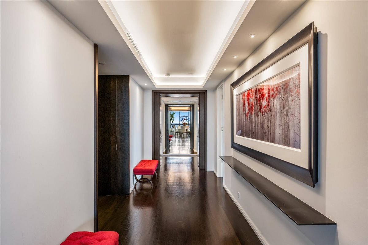 180 East Pearson Street, Unit 5107 Chicago, IL 60611 - Photo 19 of 42 a hallway with wooden floor chandelier and entryway