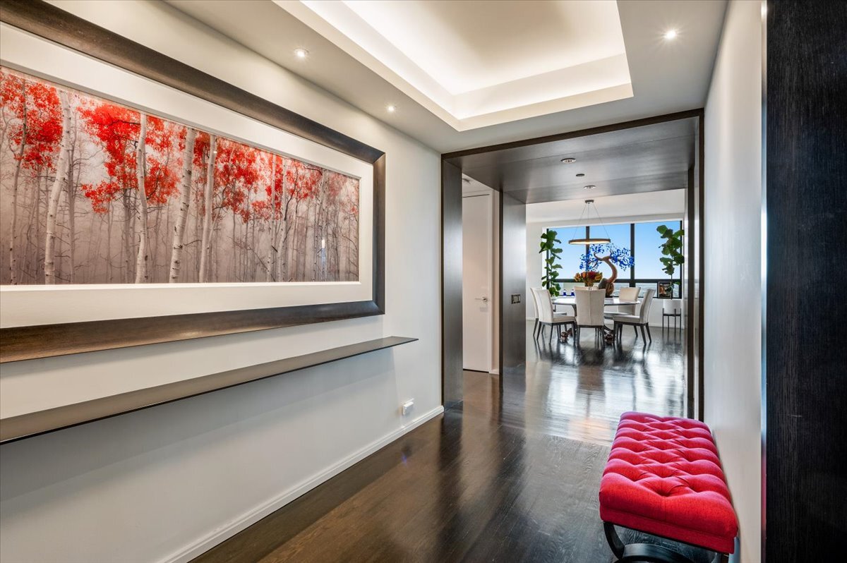 180 East Pearson Street, Unit 5107 Chicago, IL 60611 - Photo 2 of 42 a hallway with a dining table and a potted plant