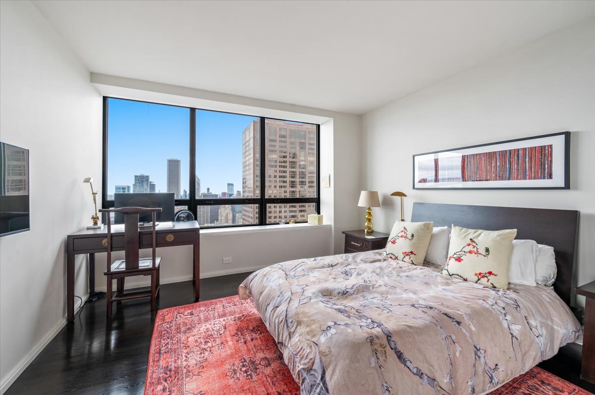 180 East Pearson Street, Unit 5107 Chicago, IL 60611 - Photo 25 of 42 a bedroom with a bed and a large window