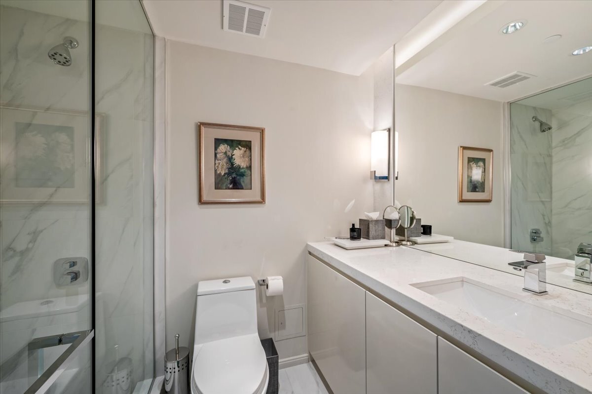 180 East Pearson Street, Unit 5107 Chicago, IL 60611 - Photo 26 of 42 a bathroom with a toilet sink and mirror