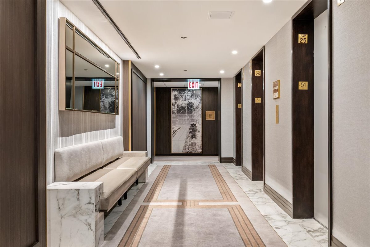 180 East Pearson Street, Unit 5107 Chicago, IL 60611 - Photo 30 of 42 a view of a hallway with wooden floor and cabinet