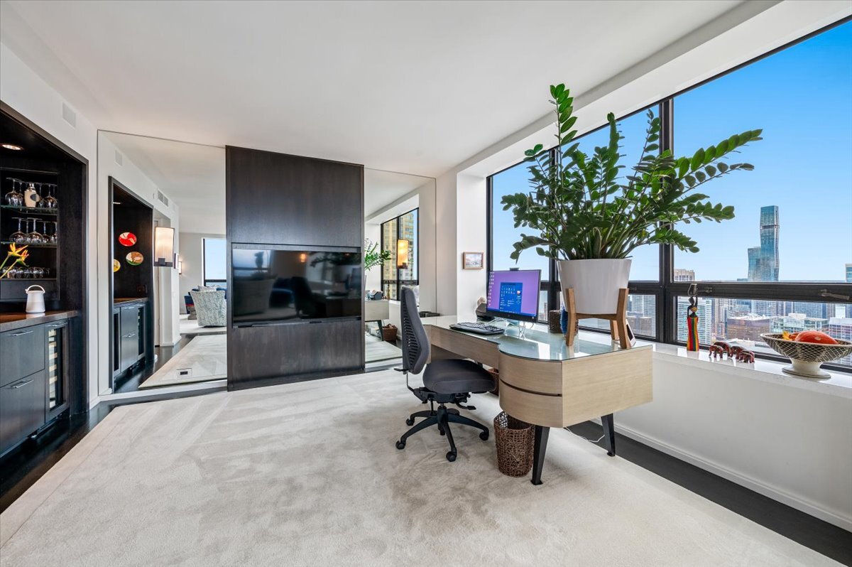 180 East Pearson Street, Unit 5107 Chicago, IL 60611 - Photo 8 of 42 a workspace with furniture and a potted plant