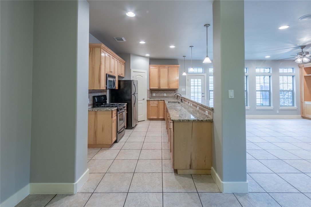 306 East 34th Street, Unit A Austin, TX 78705 - Photo 20 of 25 a large kitchen with a counter top space appliances and cabinets