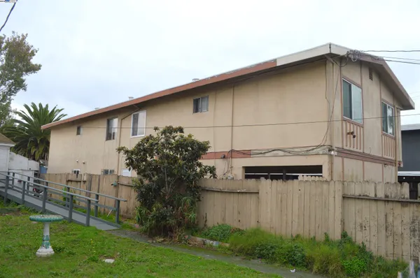 a tall white house with a outdoor space