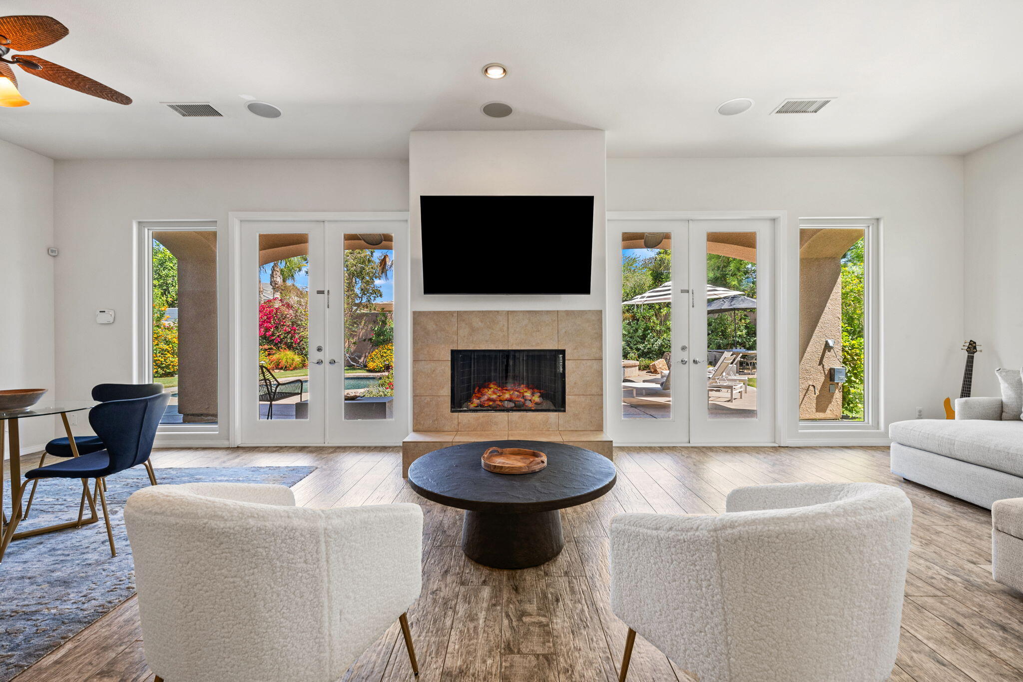 32 Calais Circle Rancho Mirage, CA 92270 - Photo 11 of 56 a living room with furniture a flat screen tv and a fireplace