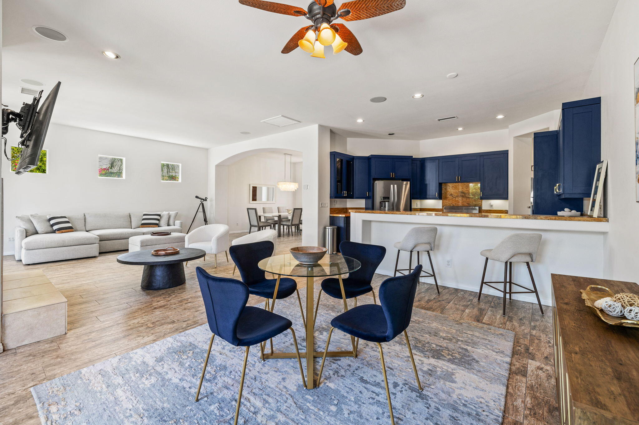 32 Calais Circle Rancho Mirage, CA 92270 - Photo 20 of 56 a living room with stainless steel appliances kitchen island granite countertop furniture and a dining table with wooden floor