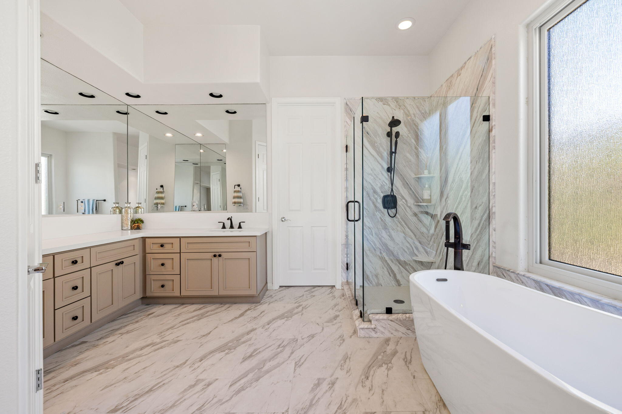 32 Calais Circle Rancho Mirage, CA 92270 - Photo 27 of 56 a spacious bathroom with a double vanity sink a mirror a bathtub and shower